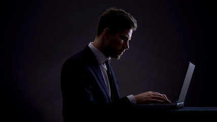 Businessman working on laptop at night shift, overworking concept, workaholic