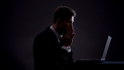 Concentrated business man working on laptop, worrying about deadline overdue
