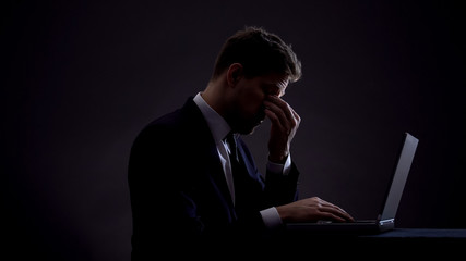 Exhausted office worker feeling tired, working on computer, night shift overwork