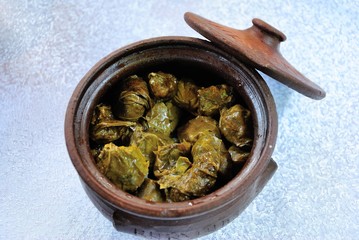 Fototapeta na wymiar Azerbaijani style meat stuffed vine leaves prepared in a clay pot in Shaki (Sheki), Azerbaijan