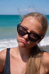 girl in sunglasses on the beach