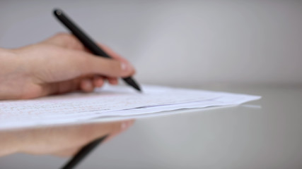 Left-handed doctor cardiologist decoding cardiogram, making prescription, health