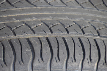 The background of the tread pattern of the car wheel. Rubber tir