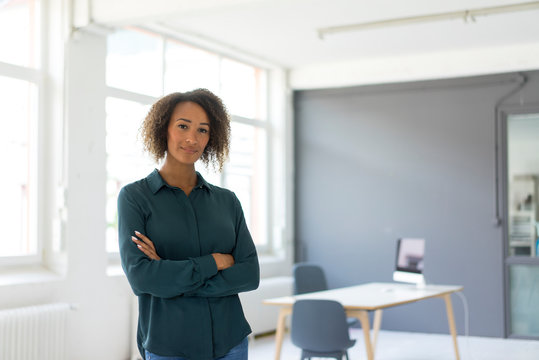 Portrait of young businesswoman in office - Powered by Adobe