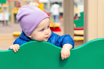 Cute adorable caucasian toddler boy enjoy having fun at outdoor playground. Portrait of happy...