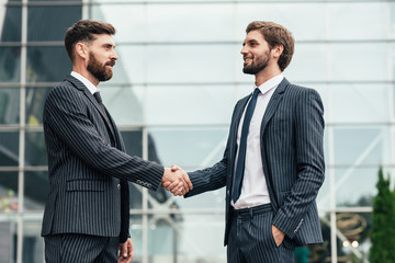 Image two business partners in elegant suit successful handshake together.Partnership approval and...