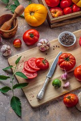 Tomatoes on cutting board with knife