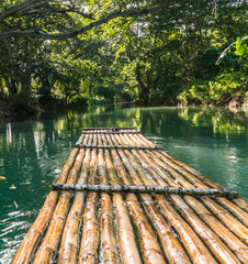 Rowing bamboo raft, Martha Brae, Jamaica. Tourist boy whilst on cruise  on vacation in Montego Bay,...