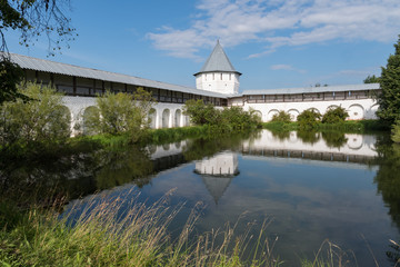 Pond with reflection of tower and wall  in Spaso-Prilutsky Monastery in Vologda, Russia
