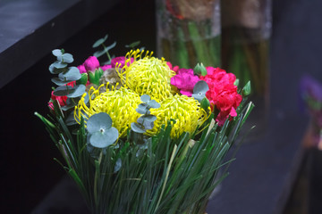 Close-up bright bouquet of seasonal flowers, chrysanthemum, tulip, eucalyptus, carnation, selective focus