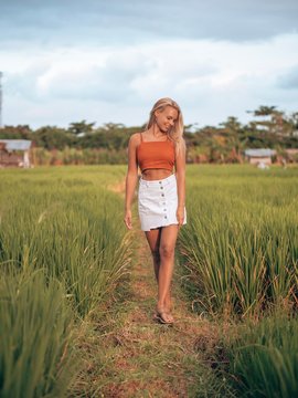 Blonde woman walking on grass