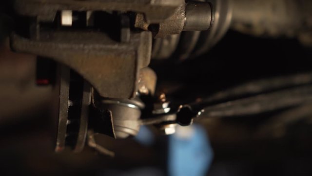 Close up of mechanic hands, swingarm regulation