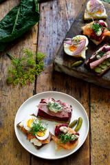Selection of Scandinavian open sandwiches with beef, beetroot and egg