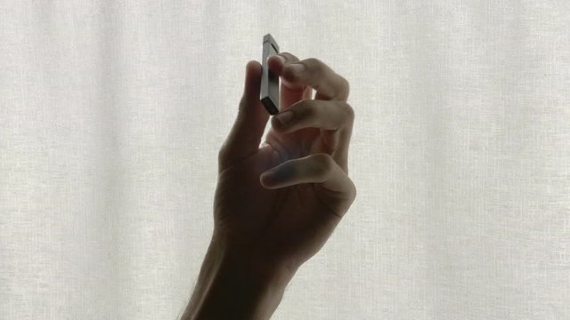 Male hand holding a vape (Juul) and playing with it. An alternative for tobacco cigarette.