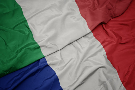 waving colorful flag of france and national flag of italy