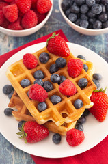 Two Classic Berry Waffles on a Rustic Blue Wood Table