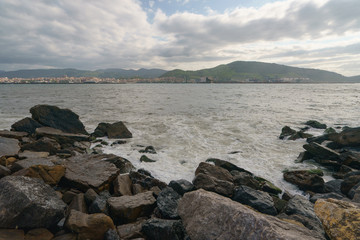 Fototapeta na wymiar Atlantic ocean, town on the shore of Biscay Bay in summer day in Basque country near Bilbao city. Natural background, suitable for banner, postcard, greeting card, poster. High resolution photography.