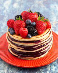 Berry Pancakes with Compote Spread on a Rustic Blue Wood Table