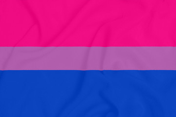 LGBT Bisexual pride community flag on a textured fabric. Pride symbol