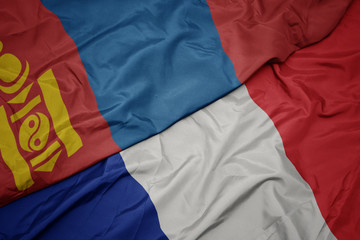 waving colorful flag of france and national flag of mongolia.