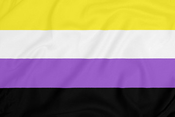 LGBT Non-binary pride community flag on a textured fabric. Pride symbol