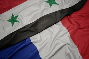 waving colorful flag of france and national flag of syria.