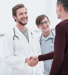 patient shaking hands with doctor.