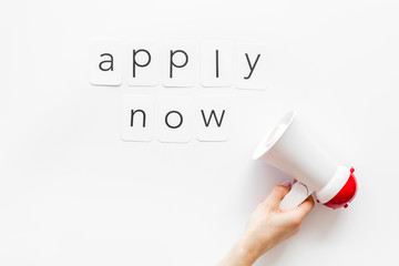 Apply now announcement symbol with megaphone and text on white background top view