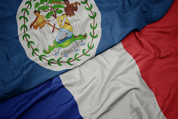 waving colorful flag of france and national flag of belize.