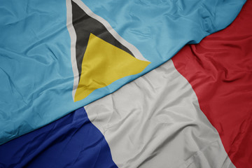 Fototapeta premium waving colorful flag of france and national flag of saint lucia.