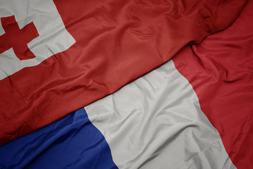 waving colorful flag of france and national flag of Tonga , .