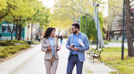 Businesswoman and architect walking and discussing