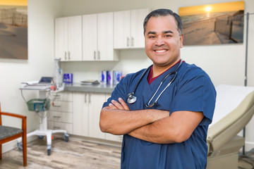 Hispanic Male Doctor Standing In Office