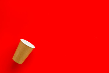 paper cups for coffee to take away on red background copyspace