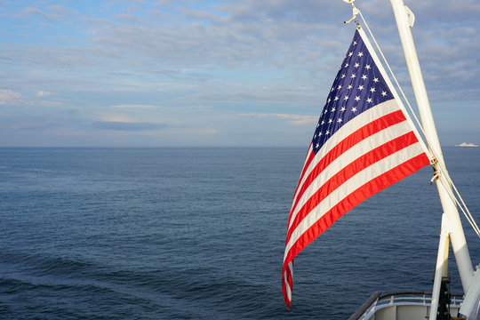 American flag of the United States of America floating off a ferry on the Atlantic Ocean