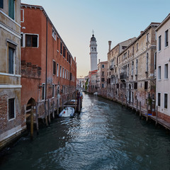 Fototapeta na wymiar Traditional narrow canal with boats in Venice, Italy. Summer
