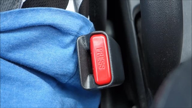 person using seat belt in modern car