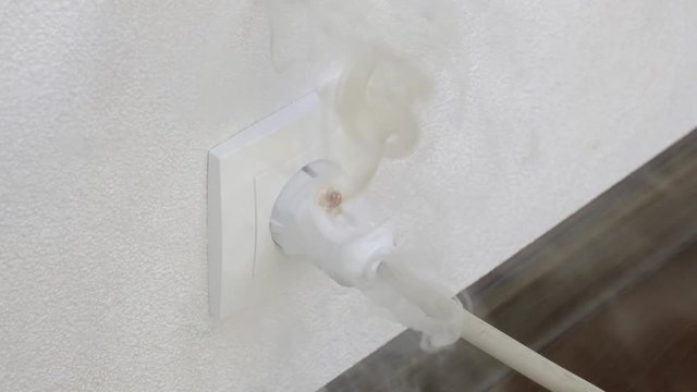 Ignition of outlet during short circuit in apartment. Concept fire from electrical appliances malpractice.