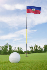 Obraz premium Haiti flag on golf course putting green with a ball near the hole