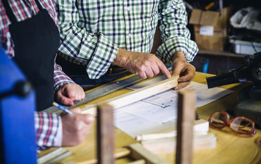 Unrecognizable senior couple working in a carpentry workshop