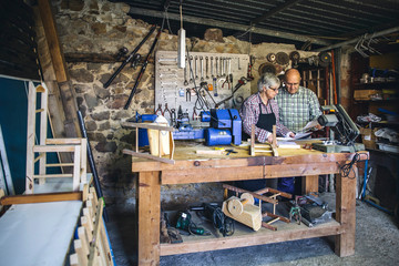 Senior couple working in a carpentry workshop
