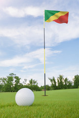 Obraz premium Republic of the Congo flag on golf course putting green with a ball near the hole