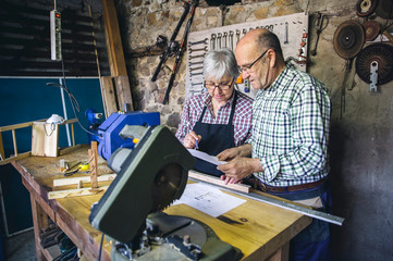 Senior couple working in a carpentry workshop