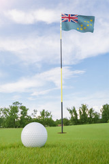 Obraz premium Tuvalu flag on golf course putting green with a ball near the hole