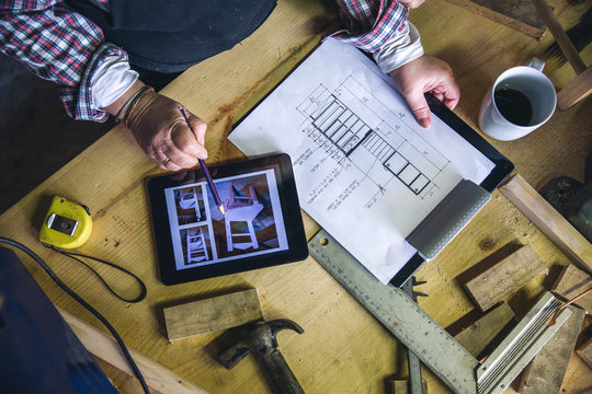 Top view of unrecognizable senior female carpenter working in a carpentry workshop