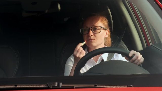 Business woman is distracted from driving a car for makeup and an accident occurs. girl makes a collision driving cars.