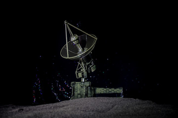 Silhouettes of satellite dishes or radio antennas against night sky. Space observatory.