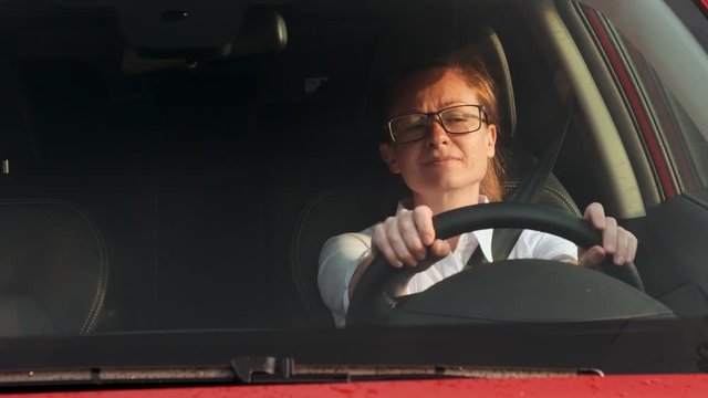 Business woman is late for work having got into traffic jam on road by car.