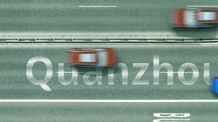 Aerial down view of the motorway with cars revealing Quanzhou caption. Car travel to China intro clip