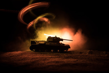 War Concept. Military silhouettes fighting scene on war fog sky background, Silhouette of armored vehicle below Cloudy Skyline At night. Attack scene. Tanks battle.